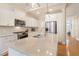 Bright kitchen with island seating featuring stainless appliances, granite countertops, and modern fixtures at 3058 Hyco Lake Ct, Fuquay Varina, NC 27526