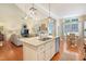 Open concept kitchen with island seating flows to dining and living room, perfect for entertaining at 3058 Hyco Lake Ct, Fuquay Varina, NC 27526