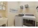 Convenient laundry room with utility sink, shelving, and washer/dryer at 3058 Hyco Lake Ct, Fuquay Varina, NC 27526