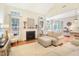 Comfortable living room featuring a fireplace, a plush sectional and hardwood floors at 3058 Hyco Lake Ct, Fuquay Varina, NC 27526