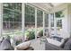Cozy screened porch with outdoor seating, perfect for enjoying nature views at 3058 Hyco Lake Ct, Fuquay Varina, NC 27526