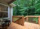 Inviting wooden back deck offers a serene outdoor space overlooking lush greenery at 3652 E Cotton Gin Dr, Clayton, NC 27527