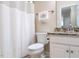 Clean and well-maintained bathroom with a toilet, shower curtain, vanity with granite countertop, and a towel rack at 3652 E Cotton Gin Dr, Clayton, NC 27527