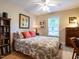 Comfortable bedroom with natural light, featuring a floral bedspread, wood furniture, and a cozy ambiance at 3652 E Cotton Gin Dr, Clayton, NC 27527