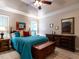 This primary bedroom features a tray ceiling with fan, and dual dressers with mirrors for a relaxing retreat at 3652 E Cotton Gin Dr, Clayton, NC 27527