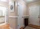 Clean hallway with hardwood floors, crisp white trim, and doors leading to the bathroom and exterior at 3652 E Cotton Gin Dr, Clayton, NC 27527