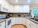 Updated kitchen with granite countertops, stainless steel appliances, and white cabinets at 3652 E Cotton Gin Dr, Clayton, NC 27527