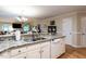 Kitchen features granite countertops, white cabinets and appliances, and an open layout to living area at 3652 E Cotton Gin Dr, Clayton, NC 27527
