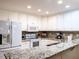 Kitchen featuring white cabinets, granite countertops and appliances at 3652 E Cotton Gin Dr, Clayton, NC 27527