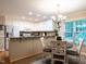 Bright kitchen with bar seating, granite countertops, white cabinets, and breakfast nook at 3652 E Cotton Gin Dr, Clayton, NC 27527