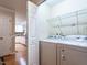 Functional laundry area featuring white appliances and wire shelving for efficient storage solutions at 3652 E Cotton Gin Dr, Clayton, NC 27527
