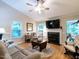 Cozy living room with a fireplace, ceiling fan, and access to a sunroom provides a comfortable gathering space at 3652 E Cotton Gin Dr, Clayton, NC 27527