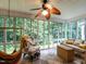 Relaxing sun room with ample natural light, comfortable seating, and tranquil views of the surrounding greenery at 3652 E Cotton Gin Dr, Clayton, NC 27527