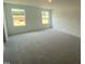 Spacious carpeted bedroom with ample natural light from two windows at 369 Thompson Overlook Way, Smithfield, NC 27577