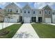 Beautiful townhomes with well-maintained lawns and driveways on a sunny day at 369 Thompson Overlook Way, Smithfield, NC 27577