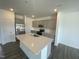 Modern kitchen features gray cabinets, stainless steel appliances and a large island with sink at 369 Thompson Overlook Way, Smithfield, NC 27577