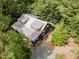 Aerial view of the home surrounded by dense foliage and lush, mature trees at 3822 Chicken Bridge Rd, Pittsboro, NC 27312