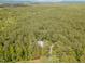 Panoramic aerial view showcases the property with its lush forest surroundings at 3822 Chicken Bridge Rd, Pittsboro, NC 27312