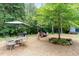 Expansive backyard featuring outdoor seating, a dining area, and a well-maintained gravel landscape at 3822 Chicken Bridge Rd, Pittsboro, NC 27312