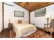 Charming bedroom with light wood ceiling, featuring a bed with decorative pillows and matching rug at 3822 Chicken Bridge Rd, Pittsboro, NC 27312