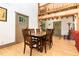The dining room features hardwood floors, access to an entryway, and an exposed-beam staircase at 3822 Chicken Bridge Rd, Pittsboro, NC 27312
