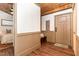 Inviting entryway features a coat rack, hardwood ceiling, wood floors, and leads into a bedroom at 3822 Chicken Bridge Rd, Pittsboro, NC 27312