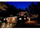 Charming exterior view of a home illuminated with warm string lights at night at 3822 Chicken Bridge Rd, Pittsboro, NC 27312