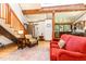 Bright living room featuring a cozy seating area and wooden staircase to the upper level at 3822 Chicken Bridge Rd, Pittsboro, NC 27312