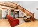 Bright and airy living room with hardwood floors, exposed wood beams, staircase, and natural light at 3822 Chicken Bridge Rd, Pittsboro, NC 27312