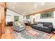 Upstairs living room featuring wood floors, natural light, a gray sofa, and a writing desk at 3822 Chicken Bridge Rd, Pittsboro, NC 27312