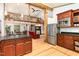 Open floor plan with kitchen, dining, and living areas featuring hardwood floors and wood beams at 3822 Chicken Bridge Rd, Pittsboro, NC 27312