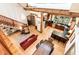 Aerial view of an open living space with exposed beams, a kitchen, dining area, and sitting area at 3822 Chicken Bridge Rd, Pittsboro, NC 27312