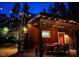 Outdoor dining area featuring a wooden table and chairs, illuminated by string lights for an enchanting ambiance at 3822 Chicken Bridge Rd, Pittsboro, NC 27312
