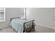 Minimalist bedroom featuring a wrought-iron bed frame and ample natural light from multiple windows at 3921 Robins Nest Ln, Wake Forest, NC 27587