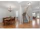 Elegant foyer featuring hardwood floors, staircase and classic chandelier at 3921 Robins Nest Ln, Wake Forest, NC 27587