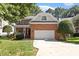 Charming brick home with a well-manicured lawn and attached two car garage at 3921 Robins Nest Ln, Wake Forest, NC 27587
