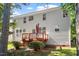 The exterior of this two-story home features a wooden deck with a railing at 3921 Robins Nest Ln, Wake Forest, NC 27587