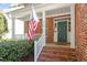 Inviting front porch with brick steps and a beautiful green front door at 3921 Robins Nest Ln, Wake Forest, NC 27587
