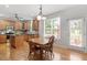 Bright and airy kitchen with wood cabinets, stainless steel appliances, and eat-in dining area at 3921 Robins Nest Ln, Wake Forest, NC 27587