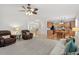 Open-concept living room with hardwood floors leading to a modern kitchen and comfortable seating at 3921 Robins Nest Ln, Wake Forest, NC 27587