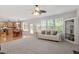 Bright living room featuring hardwood floors, built-in shelving, and open access to the kitchen at 3921 Robins Nest Ln, Wake Forest, NC 27587
