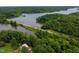 Picturesque aerial view of the property near a bridge and lake surrounded by lush greenery at 394 Flanagan Rd, Henderson, NC 27537