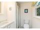 Compact bathroom featuring a sink, toilet, and shower with a curtain at 394 Flanagan Rd, Henderson, NC 27537