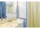 Bathroom features a sink, cabinet, mirror, and a shower with a curtain at 394 Flanagan Rd, Henderson, NC 27537