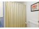 Clean bathroom with a shower curtain, toilet, and wall decor at 394 Flanagan Rd, Henderson, NC 27537