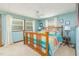 Charming bedroom with a colorful quilt, two windows, and light blue walls at 394 Flanagan Rd, Henderson, NC 27537