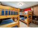 Cozy bunk bedroom with two sets of wooden bunk beds and blue bedding at 394 Flanagan Rd, Henderson, NC 27537