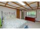 Cozy bedroom featuring exposed beams, a window with views and a comfortable bed at 394 Flanagan Rd, Henderson, NC 27537