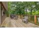 Outdoor wooden deck with chairs and a grill overlooking a lush green landscape at 394 Flanagan Rd, Henderson, NC 27537