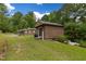 Exterior view of home's wood shed and propane tank situated on lush lawn at 394 Flanagan Rd, Henderson, NC 27537